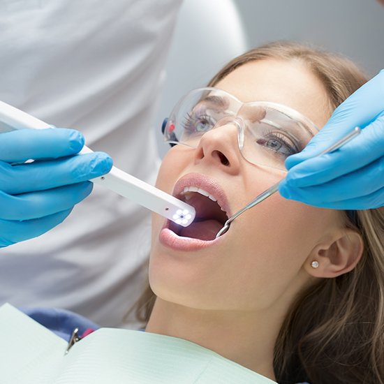 Dentist capturing intraoral images of patient's smile