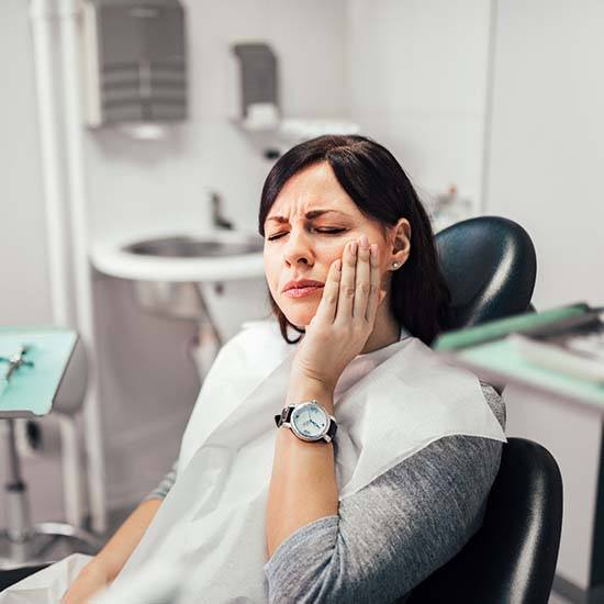 Woman with dental emergency in Arvada in a dental chair