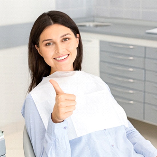 Woman smiling and giving thumbs up after nitrous oxide dental sedation visit