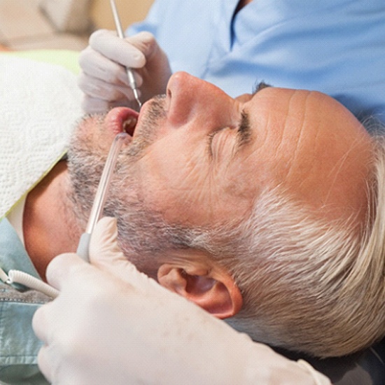 Middle-aged man relaxed during his dental appointment under dental sedation