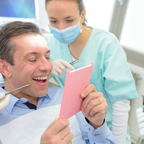 Dentist pointing to a patient’s teeth