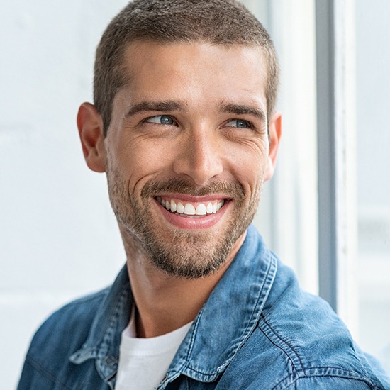 a man smiling after visiting a cosmetic dentist in Arvada