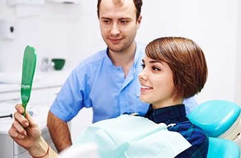 Patient smiling after receiving dental crown