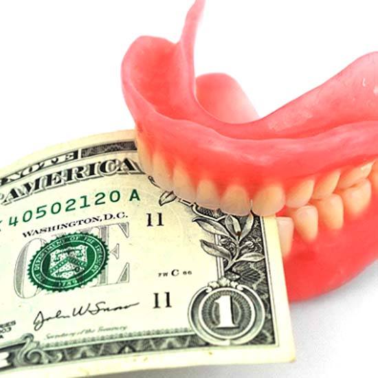 denture biting money representing the cost of dentures in Arvada