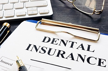 dental insurance form on a table with a keyboard