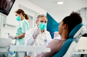 patient visiting dentist to prevent dental emergencies in Arvada