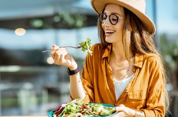 woman eating healthy to prevent dental emergencies in Arvada