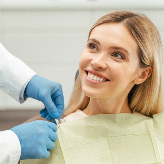 Smiling patient in a dentist’s chair