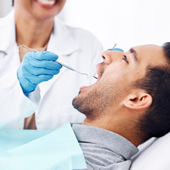 Man receiving preventive care at the dentist’s office