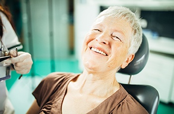 Patient smiling with her dental implant dentist in Arvada