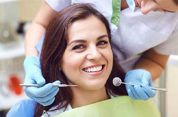 Dentist examining a patient’s dental implants in Arvada during examination