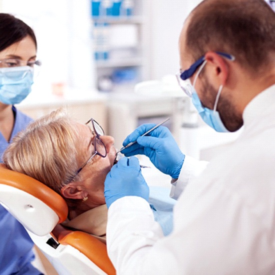 Implant dentist in Arvada performing treatment on a patient