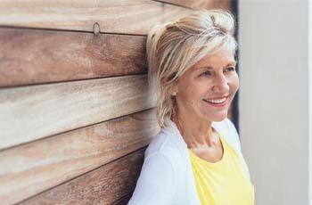 Woman smiling with dental implants in Arvada