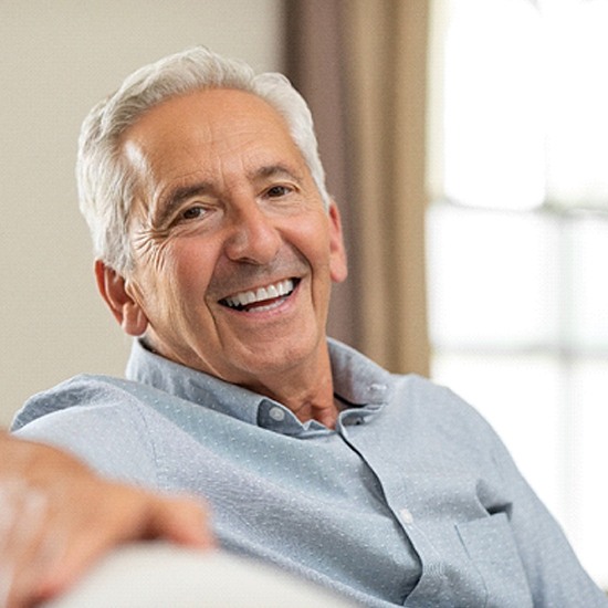 patient smiling after getting dental implants in Arvada