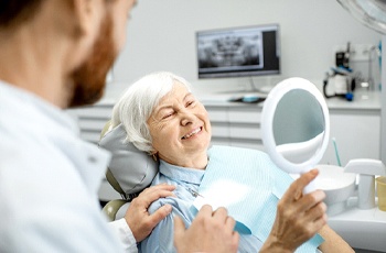 patient smiling after getting dental implants in Arvada