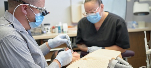 Arvada dentist and team member treating dental patient