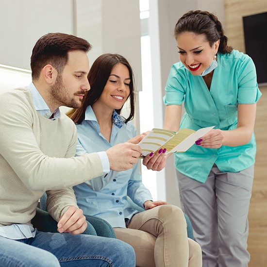 Dental team member showing patient dental insurance information