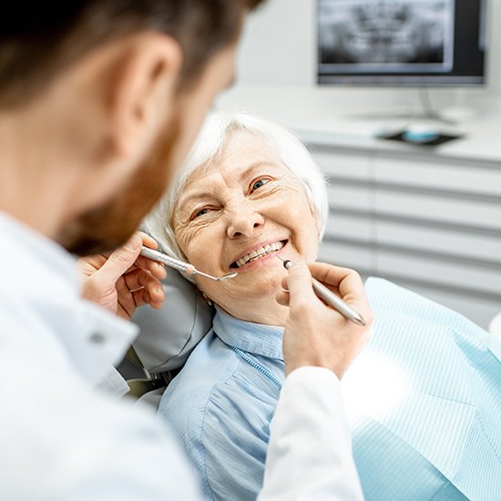 Dentist examining dental patient's smile