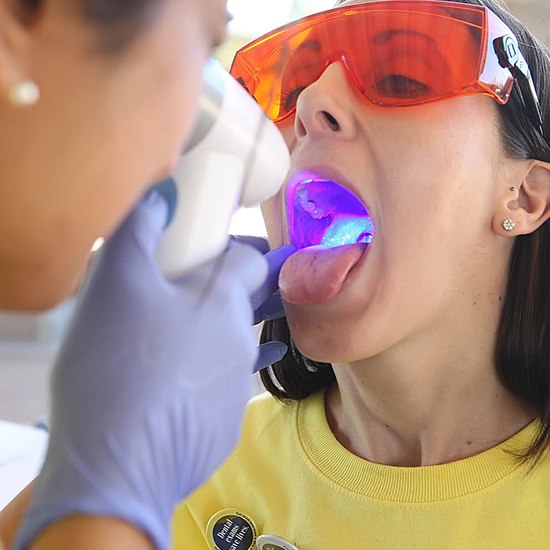 Woman receiving oral cancer screening