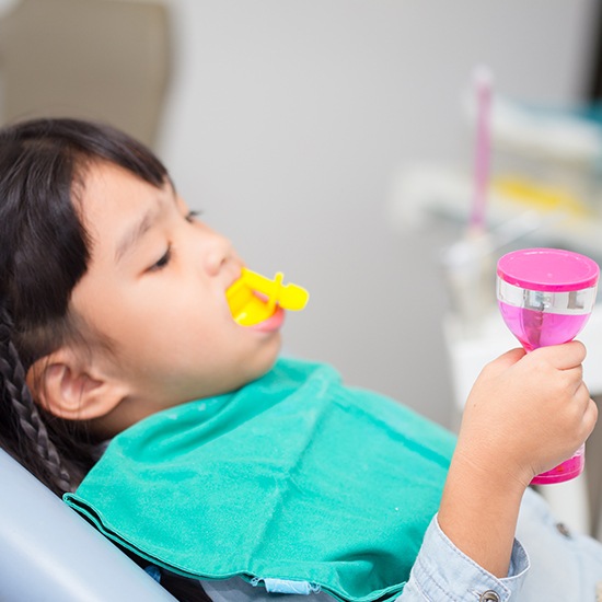 Child receiving fluoride treatment