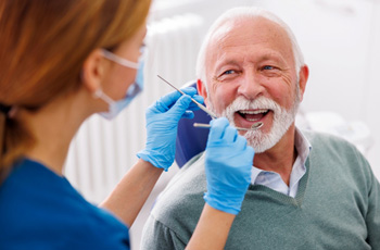 Man smiles at dentist