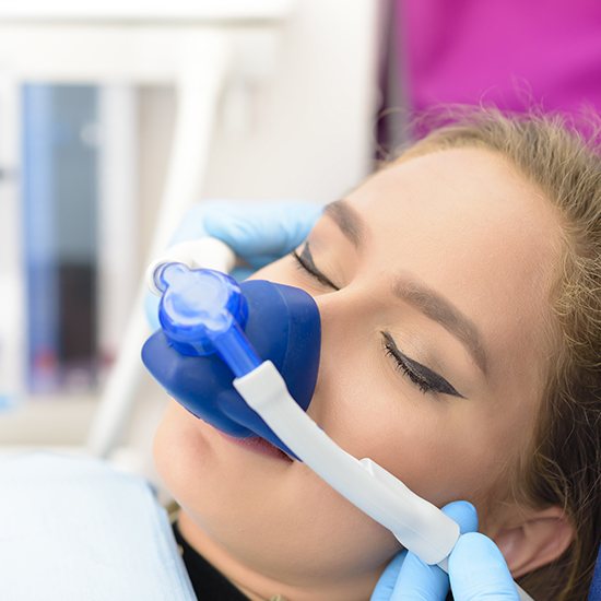 Woman with nitrous oxide sedation dentistry mask