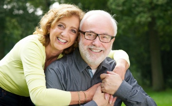 Man and woman with healthy smiles after restorative dentistry