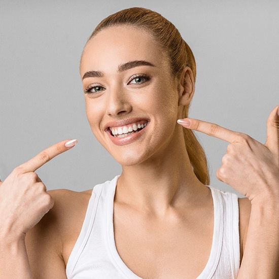 young woman smiling after getting veneers in Arvada