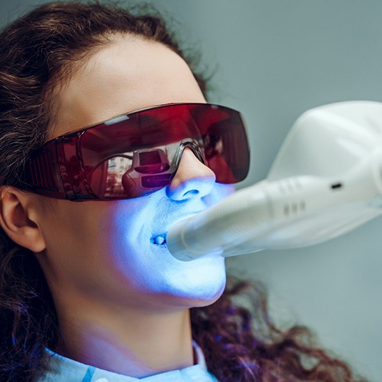 Woman having in-office whitening treatment