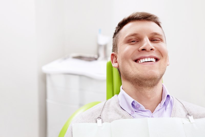 Male dental patient smiling after getting dental implants
