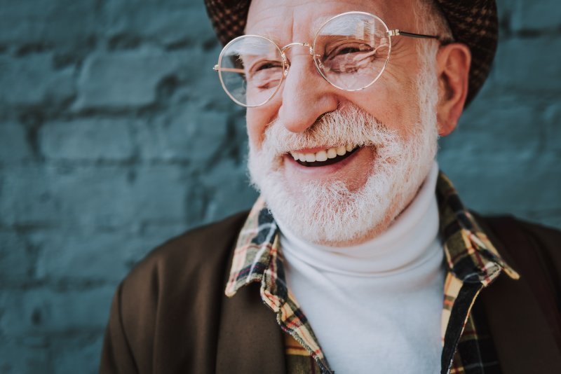 A close-up portrait of a cheerful pensioner